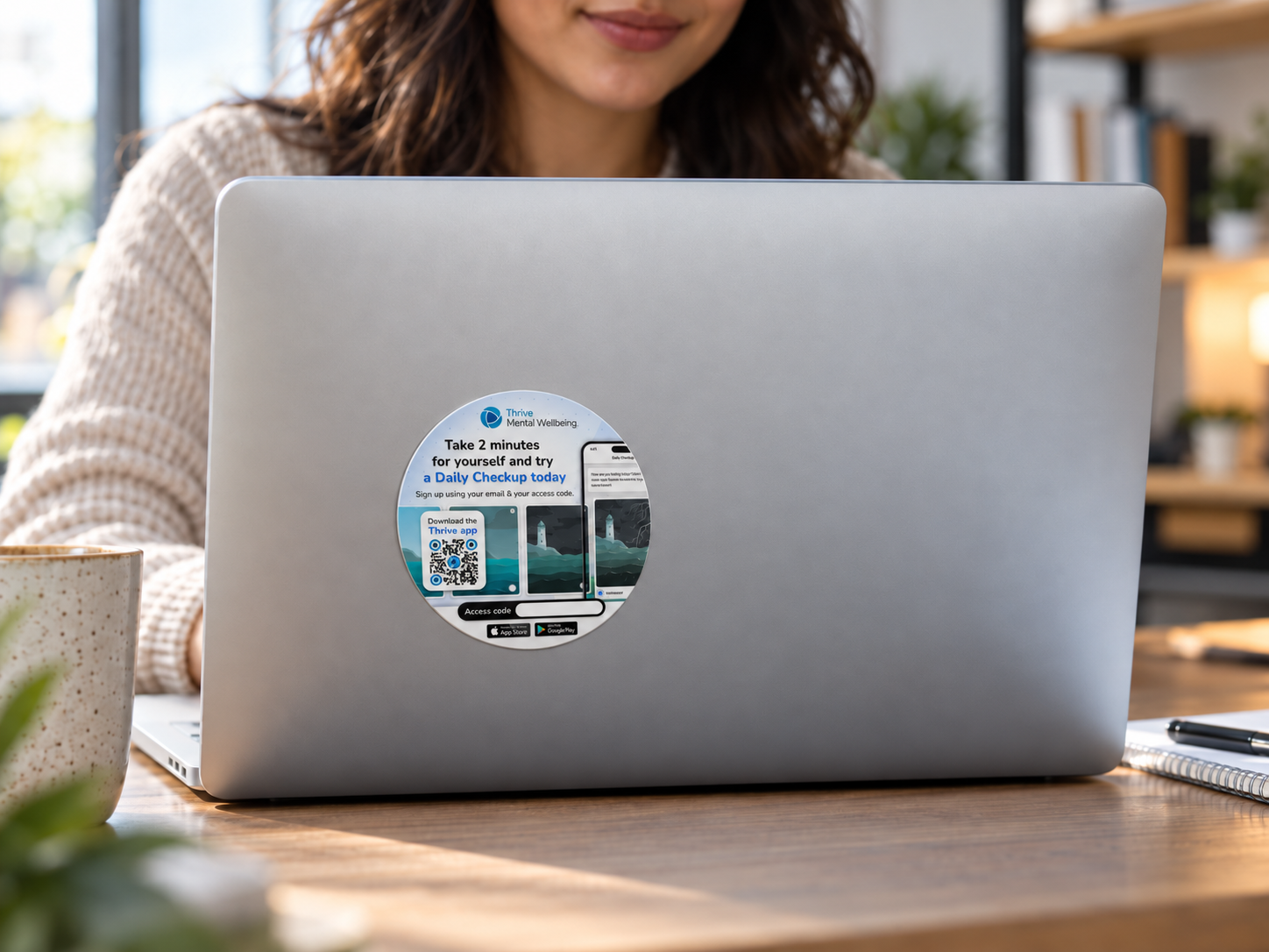 Thrive Daily Checkup campaign sticker displayed on a laptop
