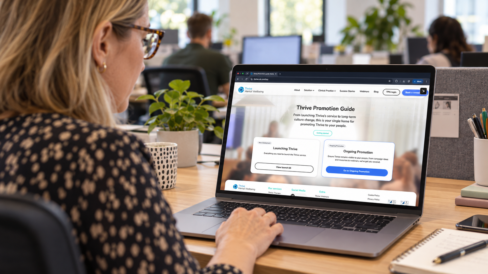 HR manager reviewing the Thrive Promotion Guide customer journey on a laptop in a workplace office
