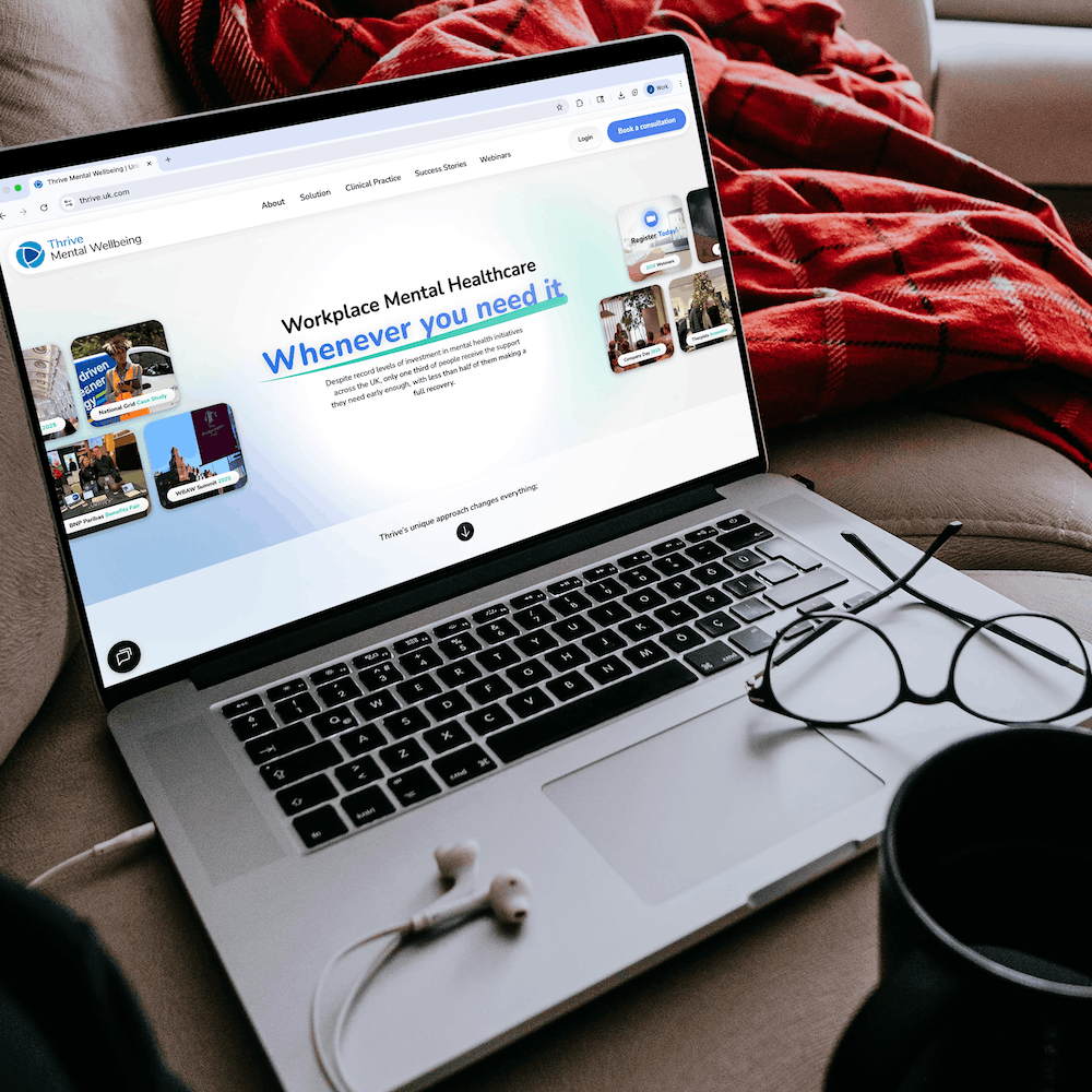Thrive Mental Wellbeing website shown on a laptop